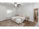 Bright bedroom with neutral decor, large windows, ceiling fan, and a view to the bathroom at 20796 Quinn St, Orlando, FL 32833