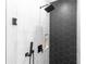 Contemporary shower with black hexagon and white subway tile and matte black fixtures at 20796 Quinn St, Orlando, FL 32833