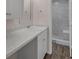 Bathroom vanity featuring white cabinetry, marble countertops, and a walk-in shower at 2206 Stonington Ave # 2206, Orlando, FL 32817
