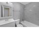Bright bathroom with white vanity, gray tile shower, and framed mirror at 2206 Stonington Ave # 2206, Orlando, FL 32817