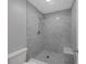 Modern bathroom with a stand up shower featuring gray tile and a pebble floor at 2206 Stonington Ave # 2206, Orlando, FL 32817