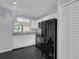 Modern kitchen with white cabinets, black appliances, and black tile floors at 2206 Stonington Ave # 2206, Orlando, FL 32817