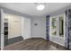 Living room with laminate flooring, a window with curtains, and an open doorway to the kitchen at 2206 Stonington Ave # 2206, Orlando, FL 32817