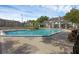 Community pool and tennis courts with outdoor seating and manicured lawns in a well-maintained exterior at 2206 Stonington Ave # 2206, Orlando, FL 32817