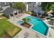 Aerial view of a community pool with sundeck, lounge chairs, and well-manicured landscaping at 2206 Stonington Ave # 2206, Orlando, FL 32817