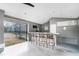 Pool house bar with modern black metal chairs, concrete floors and plenty of room for entertaining at 2206 Stonington Ave # 2206, Orlando, FL 32817