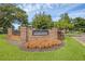 Community sign with brick base, mature landscaping, and a manicured lawn at 2206 Stonington Ave # 2206, Orlando, FL 32817