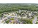 Lush aerial view of a quiet neighborhood nestled among mature trees and close to natural pond at 2216 Grand Tree Ct, Lake Mary, FL 32746