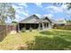 Spacious backyard with screened in porch, lush grass, and privacy fence at 2216 Grand Tree Ct, Lake Mary, FL 32746