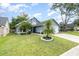 View of home showcasing front lawn, driveway, and attached two-car garage at 2216 Grand Tree Ct, Lake Mary, FL 32746