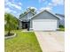 Charming home featuring a well-manicured lawn and a two-car garage at 2216 Grand Tree Ct, Lake Mary, FL 32746