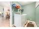 Well-organized laundry room with modern washer and dryer and shelving above at 2216 Grand Tree Ct, Lake Mary, FL 32746