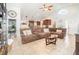 Cozy living room featuring tile floors, high ceilings, and a comfortable sectional sofa at 2216 Grand Tree Ct, Lake Mary, FL 32746