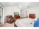 Bright main bedroom featuring a comfortable recliner, closet, and natural light at 2216 Grand Tree Ct, Lake Mary, FL 32746