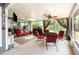 Enclosed patio featuring a ceiling fan, grill, and comfortable seating area at 2216 Grand Tree Ct, Lake Mary, FL 32746