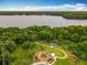 Stunning aerial view showcasing community playground, lush landscaping, and a beautiful lake at 2247 Marsh Sedge Ln, Winter Park, FL 32792