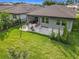 Aerial view of the home showcasing the backyard, patio with furniture and surrounding landscape at 2247 Marsh Sedge Ln, Winter Park, FL 32792