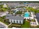 Aerial view of community pool and recreation center with palm trees and neighborhood homes at 2247 Marsh Sedge Ln, Winter Park, FL 32792