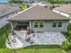 Aerial view of the backyard with a patio area, lush green lawn, and surrounding neighborhood at 2247 Marsh Sedge Ln, Winter Park, FL 32792