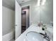 Bright bathroom features a double sink vanity, large mirror, and a shower with white tiling at 2247 Marsh Sedge Ln, Winter Park, FL 32792
