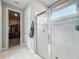 Modern bathroom featuring a glass-enclosed shower with marble-look tiles and access to a walk-in closet at 2247 Marsh Sedge Ln, Winter Park, FL 32792