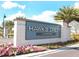 Elegant community sign for Hawk's Crest at Winter Park, surrounded by lush landscaping and flowers at 2247 Marsh Sedge Ln, Winter Park, FL 32792