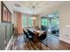Bright dining room features a wood table, modern chairs, and sliding glass doors to the lanai at 2247 Marsh Sedge Ln, Winter Park, FL 32792