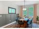 Elegant dining room with a wood table, modern chairs, stylish mirror, and ample natural light at 2247 Marsh Sedge Ln, Winter Park, FL 32792