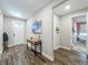 Bright entryway with wood floors, a stylish console table, and views into other rooms at 2247 Marsh Sedge Ln, Winter Park, FL 32792