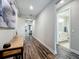 Inviting hallway with wood floors and a view leading into the living room and bathroom at 2247 Marsh Sedge Ln, Winter Park, FL 32792