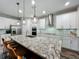 Spacious kitchen with a large island, granite countertops, stainless steel appliances, and pendant lighting at 2247 Marsh Sedge Ln, Winter Park, FL 32792