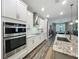 Stylish kitchen with white cabinets, granite countertops, and stainless steel appliances at 2247 Marsh Sedge Ln, Winter Park, FL 32792