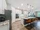 Modern kitchen with stainless steel appliances, granite countertops, and an island with seating at 2247 Marsh Sedge Ln, Winter Park, FL 32792