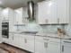 Modern kitchen featuring granite countertops, stainless steel appliances, and stylish white cabinetry at 2247 Marsh Sedge Ln, Winter Park, FL 32792