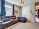 Cozy living area featuring a leather reclining sofa, comfortable beanbag, and unique decorative touches at 2247 Marsh Sedge Ln, Winter Park, FL 32792