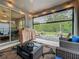 Relaxing covered patio with comfortable seating, a grill, and a view of the green backyard at 2247 Marsh Sedge Ln, Winter Park, FL 32792