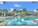 Stunning community pool with palm trees and lounge seating, perfect for relaxation and recreation at 2247 Marsh Sedge Ln, Winter Park, FL 32792