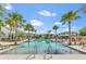 Inviting community pool with clear blue water, lounge chairs and palm trees for a resort-style feel at 2247 Marsh Sedge Ln, Winter Park, FL 32792