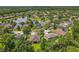 An aerial view displays the landscape, a peaceful pond, and the surrounding neighborhood at 2274 Foliage Oak Ter, Oviedo, FL 32766