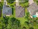 An aerial view of a well-maintained property with a large yard and mature trees at 2274 Foliage Oak Ter, Oviedo, FL 32766