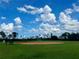 Outdoor baseball field on a sunny day with green grass and bases ready for a ball game at 2274 Foliage Oak Ter, Oviedo, FL 32766