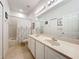 Well-lit bathroom with dual sinks, vanity area, and a shower with a tub at 2274 Foliage Oak Ter, Oviedo, FL 32766