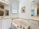Bathroom featuring a soaking tub, dual sinks, and natural light from the window at 2274 Foliage Oak Ter, Oviedo, FL 32766