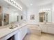 Bathroom featuring dual sinks, vanity area, soaking tub, and updated fixtures at 2274 Foliage Oak Ter, Oviedo, FL 32766