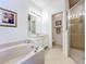 Bright bathroom featuring a soaking tub, vanity, and a separate shower at 2274 Foliage Oak Ter, Oviedo, FL 32766