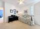 A cozy spare bedroom with neutral walls and carpet and houses a piano, bed, and closet space at 2274 Foliage Oak Ter, Oviedo, FL 32766