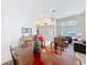 Open concept dining room and living room with a dining room table and piano at 2274 Foliage Oak Ter, Oviedo, FL 32766