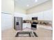 Bright kitchen with stainless steel appliances, white cabinets, and ample counter space at 2274 Foliage Oak Ter, Oviedo, FL 32766