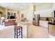 Bright, open kitchen with breakfast bar, stainless appliances, and seamless flow into the living space at 2274 Foliage Oak Ter, Oviedo, FL 32766