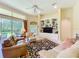 Comfortable living room with built-in shelving, a ceiling fan, and access to the outdoor area at 2274 Foliage Oak Ter, Oviedo, FL 32766